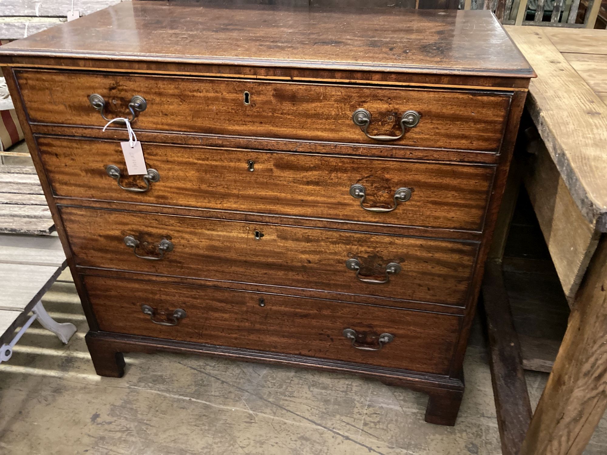A late George III mahogany straight front chest, of four long graduated drawers, width 93cm, depth 50cm, height 86cm